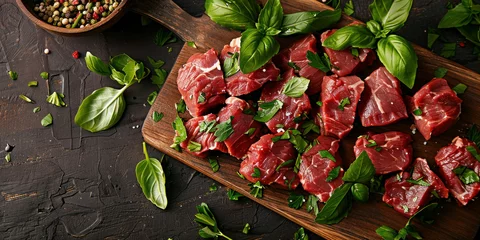  Fresh raw beef steak seasoned with herbs and spices on a wooden cutting board, top view on rustic table © SHOTPRIME STUDIO