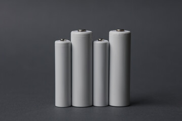 AAA and AA batteries on a dark gray background. Mockup for design