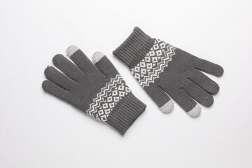 Knitted gloves on white background. Top view