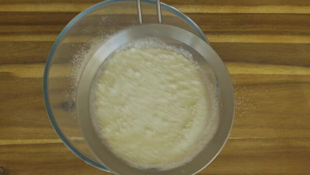 sieve flour into mixing bowl.