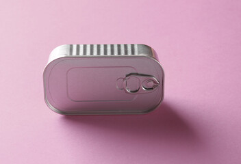 Sealed tin can on pink background.