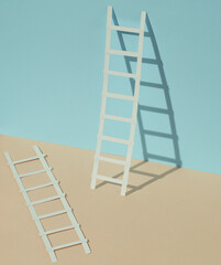Paper ladders on a blue yellow pastel background. Creative layout, business, career growth concept