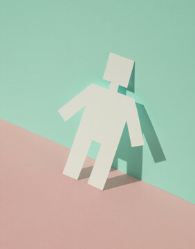 Paper-cut robot on blue-pink pastel background. Creative layout