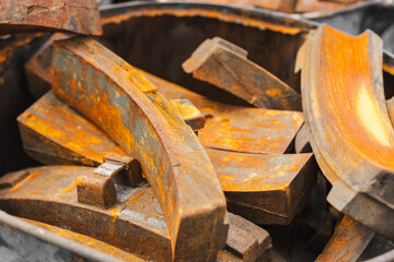 pile of rusty metal pieces used old part of train brake pad garbage rusted steel texture.