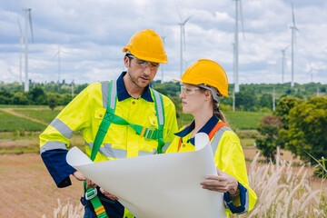 Engineer team working group survey at wind turbine clean power generator service maintenance wind mill outdoor.