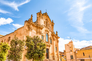 View of the ancient town of Matera, Sassi di Matera in Basilicata, southern Italy. Chiesa di San Francesco d'Assisi - obrazy, fototapety, plakaty