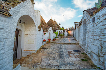 Trulli of Alberobello, Puglia, Italy. town of Alberobello with trulli houses among green plants and...