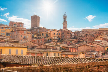 Fototapeta premium Siena, medieval town in Tuscany, with view of the Dome & Bell Tower of Siena Cathedral, Mangia Tower and Basilica of San Domenico, Italy