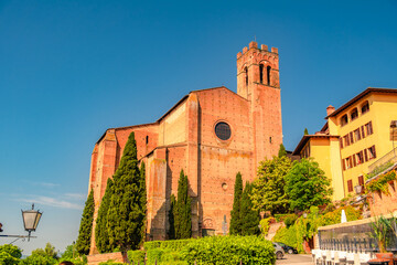 Naklejka premium Siena, medieval town in Tuscany, with view of the Dome & Bell Tower of Siena Cathedral, Mangia Tower and Basilica of San Domenico, Italy