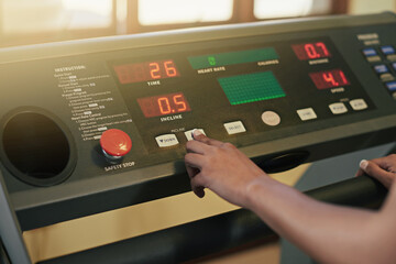 Hand, treadmill and button with machine, training or gym equipment for workout with speed. Person,...