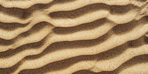 Rippled sand texture with shadow and light creating wavy patterns on a beach