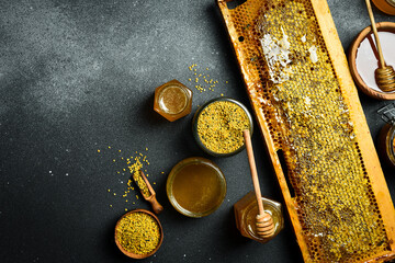 Beekeeping products. Honey in honeycombs, bee pollen, and honey. Top view. - 788116205