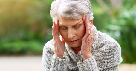 Headache, stress and senior woman in outdoor park for anxiety, burnout or depression in retirement home. and elderly female person with migraine in backyard garden for pain, sore head or fatigue - obrazy, fototapety, plakaty