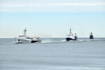 Flotilla of Russian warships sailing toward military target, armed warships ready for attack enemy...