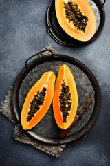  Tropical fruit papaya. Sliced ripe papaya fruit on a metal tray. Top view. © Yaruniv-Studio
