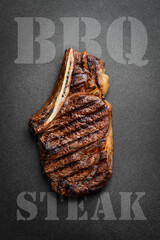 Steak on the bone. tomahawk steak On a black wooden background. Top view. Free copy space. - 788119296