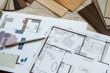 House sketch plan blue print with  material color samples and other art tools in office desk