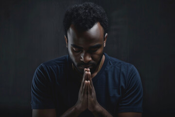 Faith, christian and praying black man in dark background with trust, hope or gratitude with prayer. Religion, male person and hands together to seek guidance, wisdom or blessings for personal growth