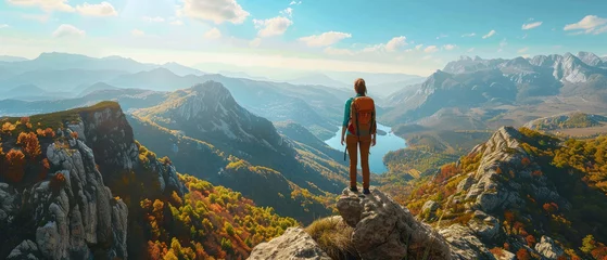 Fotobehang Back view traveler with hiking backpack standing and admiring beautiful landscape view from mountain peak with cloudy sunny weather and mountains in the distance created with Generative AI Technology © AstraNova