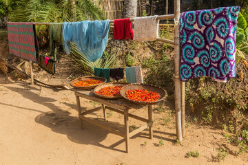 Laundry and drying chilli peppers in Donkhoun (Done Khoun) village near Nong Khiaw, Laos