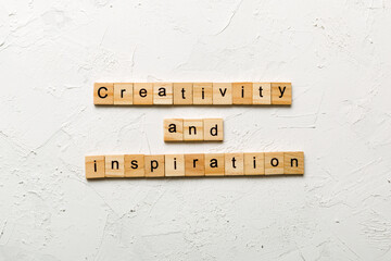 creativity and inspiration word written on wood block. creativity and inspiration text on cement table for your desing, concept