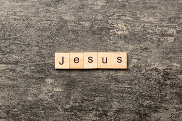 Jesus word written on wood block. Jesus text on table, concept