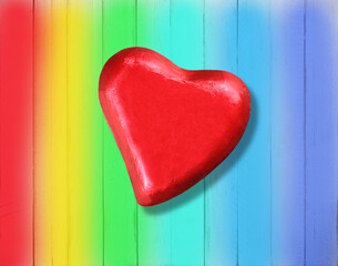 Rea heart on a wooden table with rainbow peace background with copy space for your textb