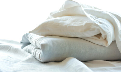 Soft, neatly folded linens in calming colors arranged on a bedspread during daylight, evoking a sense of tranquility and comfort in a cozy bedroom setting