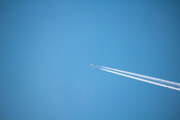 Airplane with contrail high in the sky