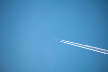 Airplane with contrail high in the sky