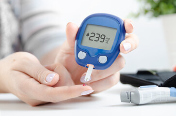 Checking blood sugar level from patient hand