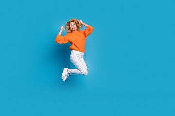 Fototapeta na wymiar Photo of charming cheerful lovely woman wear stylish orange clothes yes empty space offer isolated on blue color background