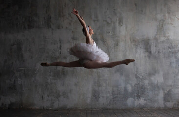 Ballerina performs a jump during a ballet dance.