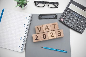 A wooden block with the word VAT 2023
