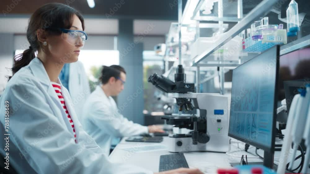 Poster female biotechnologist studying genetic samples on a computer screen. young specialist researching d