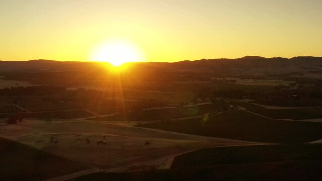 Bright sun rising in Barossa valley wine making region of South Australia as aerial flying.

