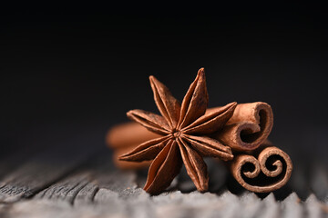 Anise star and cinnamon sticks on wooden board close up. Studio macro shot. Food photography