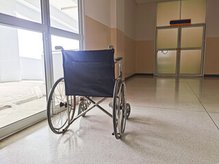 Fototapeta na wymiar Behind an empty wheelchair in a hospital