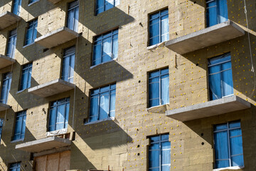 Installation of insulation on the exterior facade of a multi-storey residential building