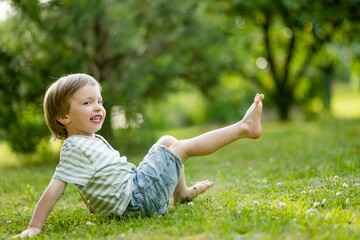 Adorable little boy having fun outdoors on sunny summer day. Kid running outdoors. Child exploring nature. Summer activities for kids. - 788167280