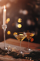 Glasses of sparkling wine on wooden table on Christmas