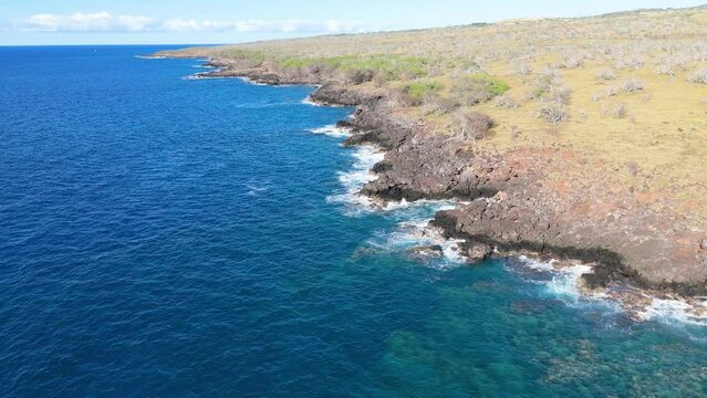 Aerial view of rocky coastline and clear blue water, Hawi, Hawaii Island, United States.