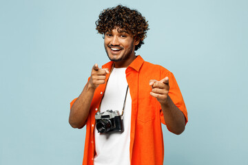 Traveler Indian man wear orange casual clothes point index finger camera on you motivating isolated...