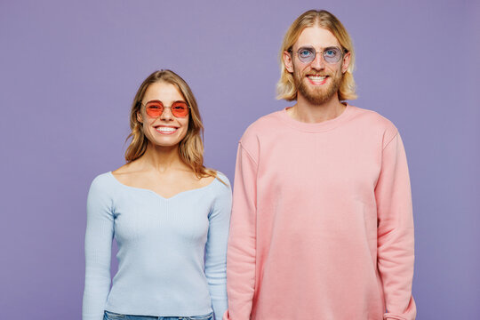 Young Smiling Happy Couple Two Friend Family Man Woman Wear Pink Blue Casual Clothes Sunglasses Together Look Camera With Toothy Smile Isolated On Pastel Plain Light Purple Background Studio Portrait