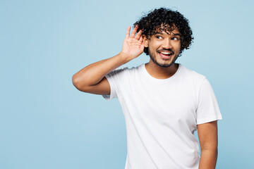 Young curious nosy Indian man he wear white t-shirt casual clothes try to hear you overhear...