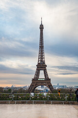 PARIS, FRANCE - MARCH 30, 2024: Eiffel Tower seen from the Jardins du Trocadero in Paris, France. Eiffel Tower is one of the most iconic landmarks of Paris - obrazy, fototapety, plakaty