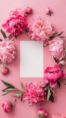 Blank square card surrounded by pastel colored flowers on a light pink background