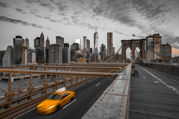 View of Brooklyn Bridge and Manhattan skyline at sunset, New York, United States.