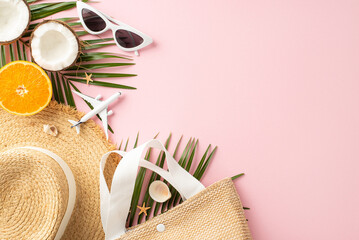 Summer travel essentials including sunglasses, a straw hat, coconut, orange slice, airplane model, and tropical leaves against a pink backdrop, evoking a sense of holiday excitement