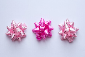 dotty pink bows on a white background, top view.
